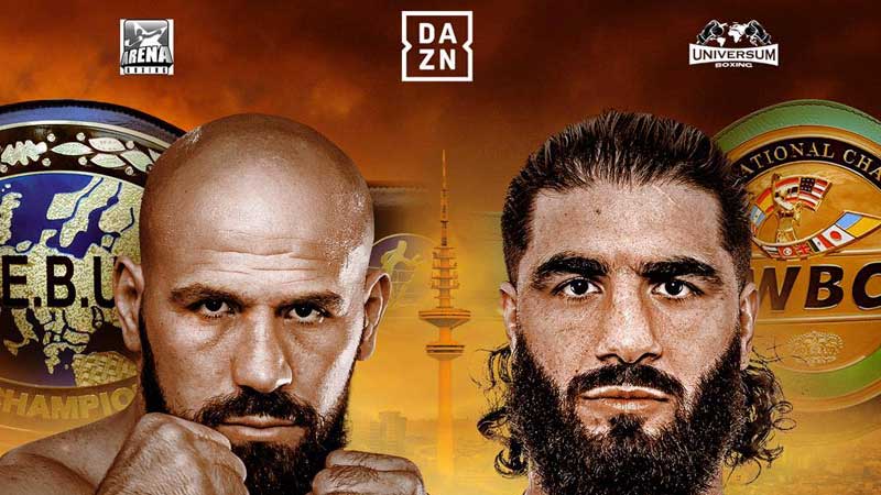 Promotional poster featuring two male boxers facing forward with serious expressions, championship boxing belts and logos in the background, and a sunset or fiery sky behind them.