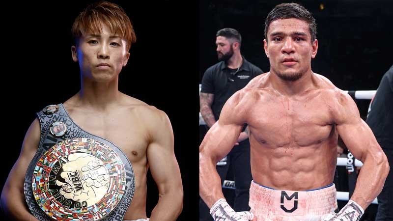 Two male boxers stand side by side. The boxer on the left wears a championship belt over his shoulder. Both are shirtless, showing muscular physiques, and look confidently at the camera in a sports setting.